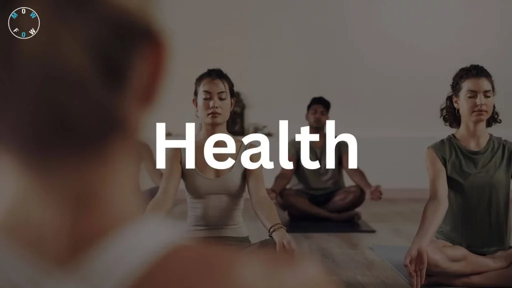 A group of four people practicing yoga or meditation, seated cross-legged on yoga mats on a wooden floor in a serene indoor setting with a light-colored wall. They wear casual clothing, including a beige tank top and a green sleeveless top, with eyes closed and hands resting on knees. The word "Health" in large, bold white text is centered over the image, and a circular logo reading "MOWFOW" is in the top left corner